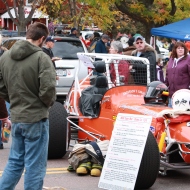 Karl Kakuk, a senior mechanical engineering student at UMD, examines the number 24 Super Mod Champ Racecar displayed on the street in Bayfield, Wisc., at the Apple Festival on Saturday