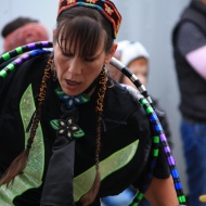 Gretchen, the leader of the hoops dance, concentrates on the rhythm of the drum, Saturday, at the Ojibwe Drum and Dance Troop performance at the Apple Festival.